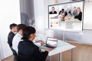 Group Of Businesspeople In Video Conference At Business Meeting